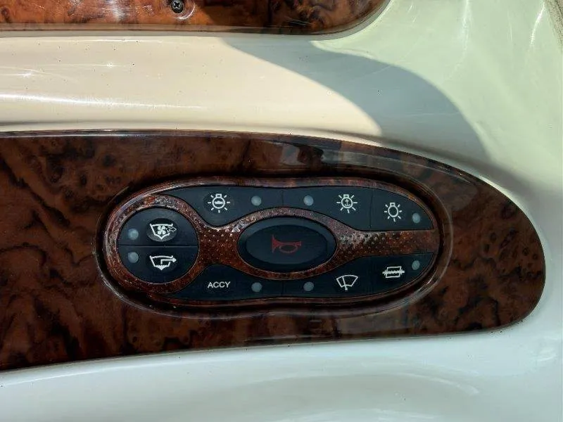 Slide: The Image of Close-up of a control panel with various symbols on a Sea Ray 240 Sundeck boat. - 33