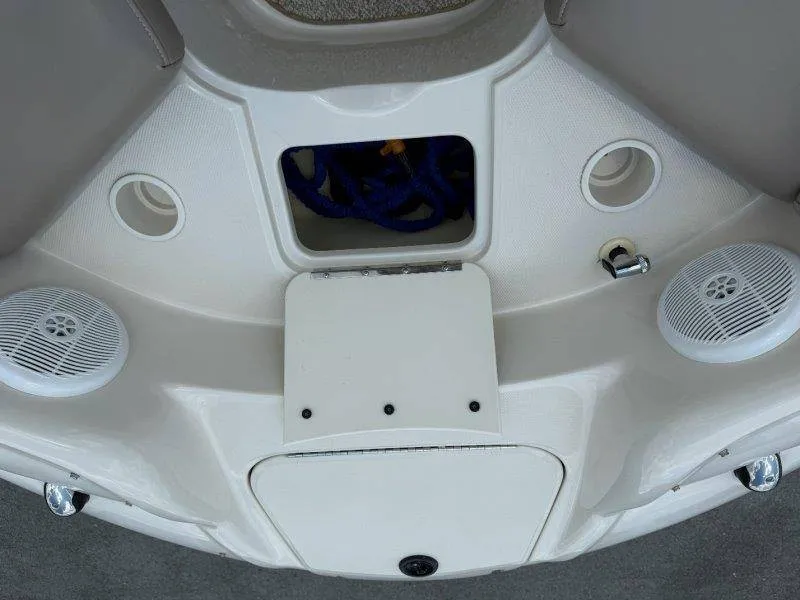 Slide: The Image of The image shows the deck of a 2003 Sea Ray 240 Sundeck boat with speakers and storage. - 30