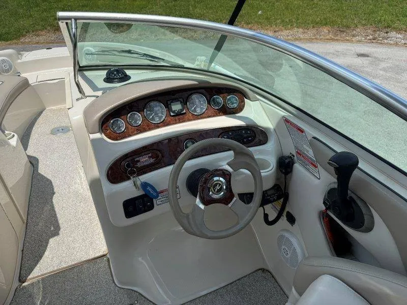 Slide: The Image of The image shows the cockpit of a 2003 Sea Ray 240 Sundeck with a sleek dashboard. - 27