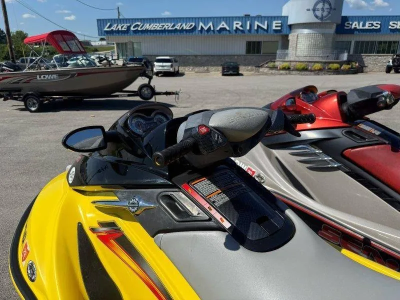 Slide: The Image of Two Sea-Doo jet skis are parked in front of a marine dealership. - 4