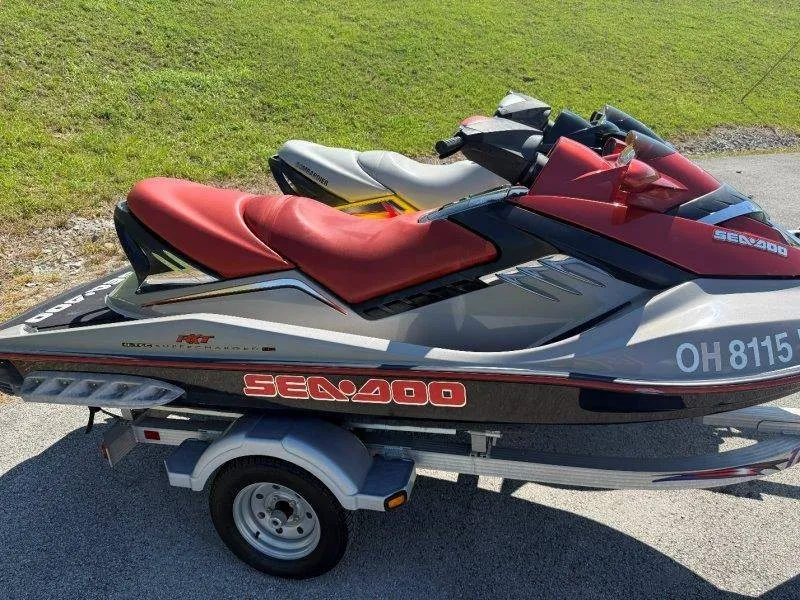 Slide: The Image of Two Sea-Doo jet skis on a trailer, featuring red seats and a sporty design. - 8