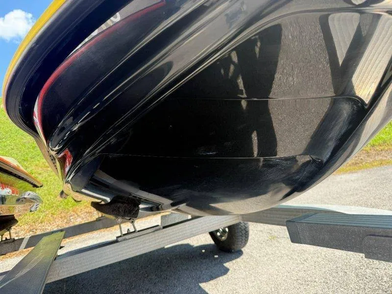 Slide: The Image of Close-up of a Sea-Doo jet ski hull on a trailer, featuring a glossy black surface. - 19