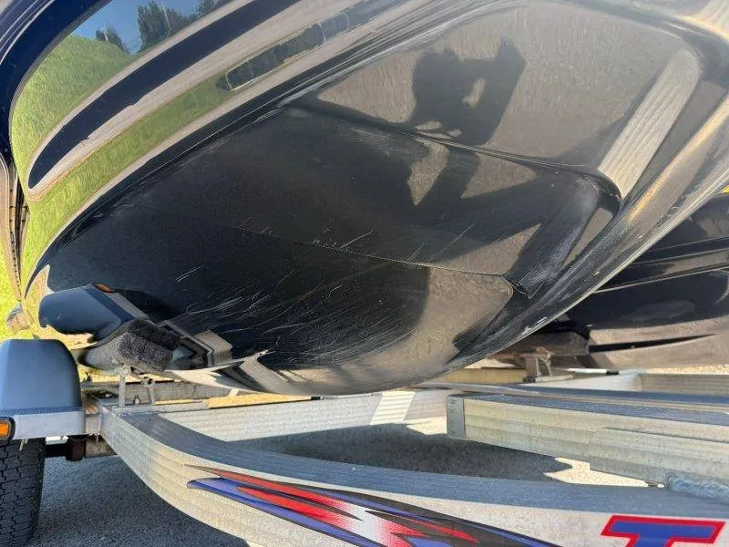 Slide: The Image of Close-up of a Sea-Doo jet ski hull on a trailer, showing visible scratches. - 26