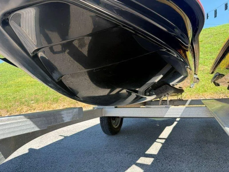 Slide: The Image of Close-up of a Sea-Doo hull on a trailer, with green grass in the background. - 20