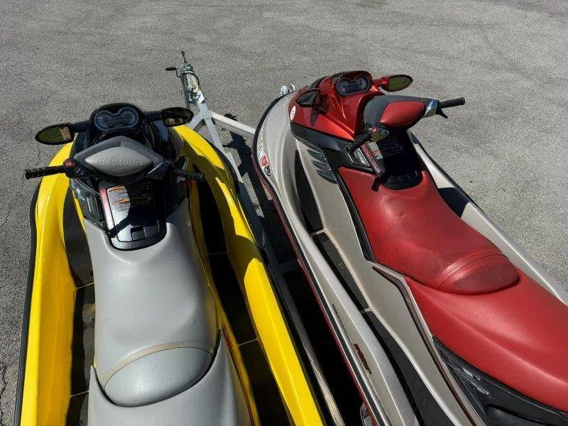 Slide: The Image of Two Sea-Doo jet skis, yellow and red, on a trailer. - 24