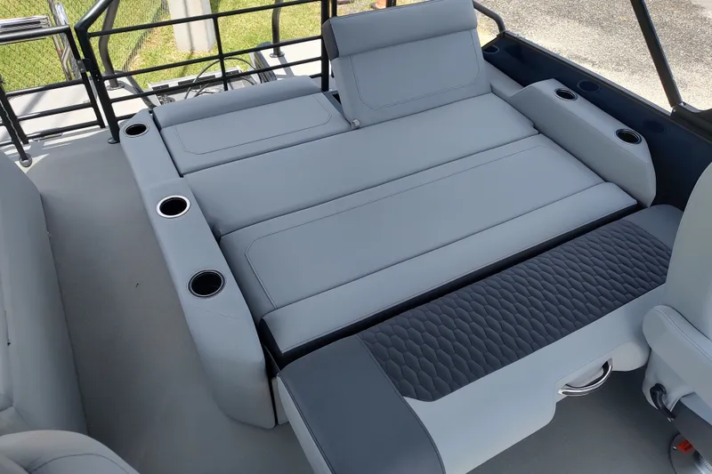 Slide: The Image of Luxurious seating area on 2027 Sylvan X1 ULZ boat with cup holders and quilted upholstery. - 13