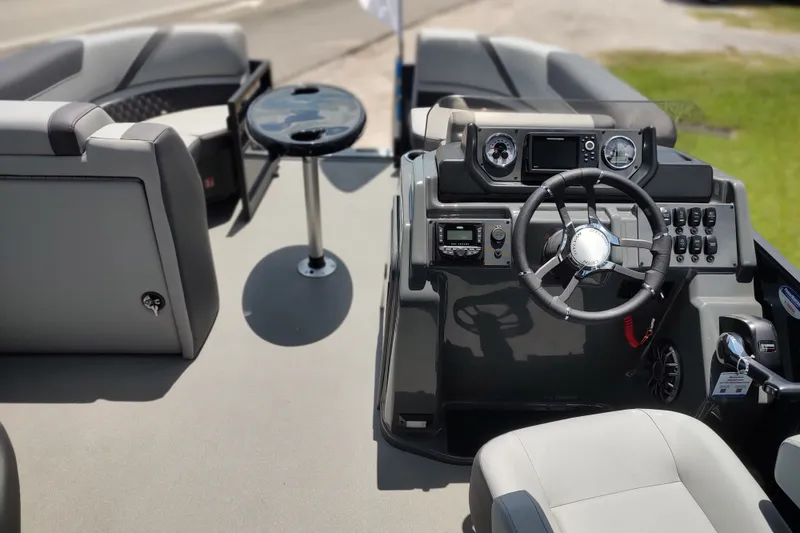 Slide: The Image of 2027 Sylvan X1 ULZ boat interior with steering wheel and control panel. - 1