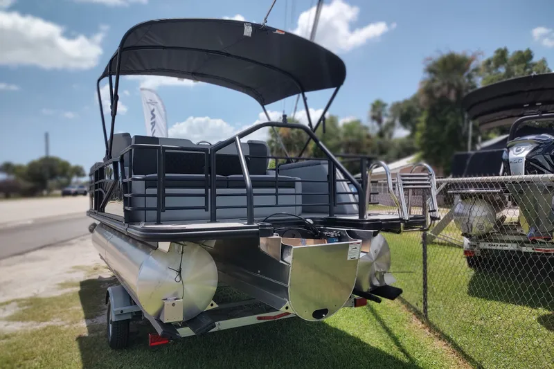 Slide: The Image of 2027 Sylvan X1 ULZ pontoon boat with canopy, parked on a trailer. - 5