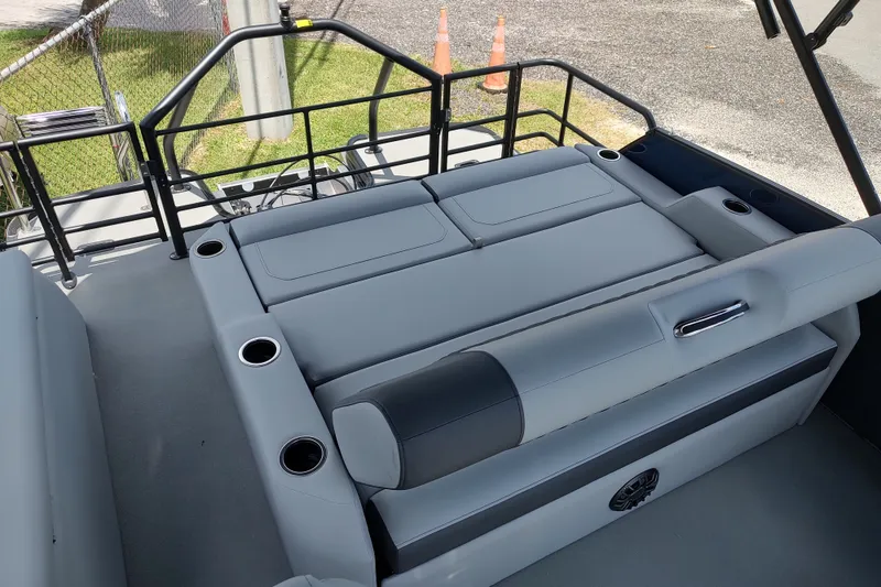 Slide: The Image of 2027 Sylvan X1 ULZ boat interior with gray seating and cup holders. - 10