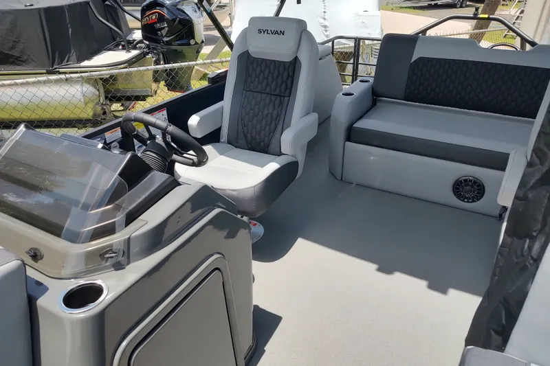 Slide: The Image of 2027 Sylvan X1 ULZ boat interior with steering console and seating area. - 14