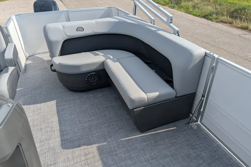 Slide: The Image of 2027 Sun Tracker Party Barge 18 DLX interior with gray seating and cup holders. - 16