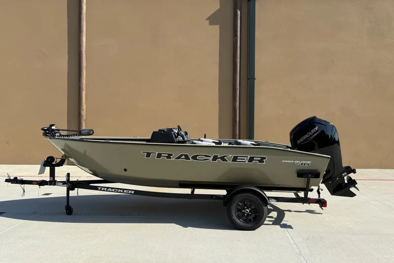 The Image of 2027 Tracker Pro Guide V-16 SC boat on trailer, side view, outdoors. - 0