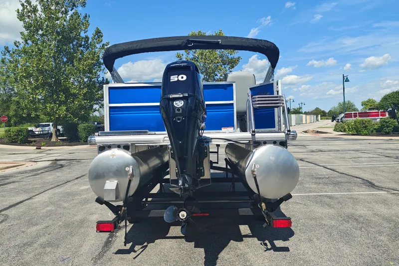 Slide: The Image of 2027 Sun Tracker Party Barge 16 DLX pontoon boat with 50 HP engine, parked outdoors. - 25