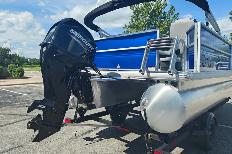 Slide: The Image of 2027 Sun Tracker Party Barge 16 DLX with Mercury outboard motor in parking lot. - 23