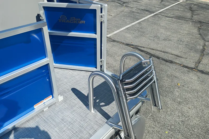 Slide: The Image of 2027 Sun Tracker Party Barge 16 DLX with blue panels and a foldable ladder. - 20