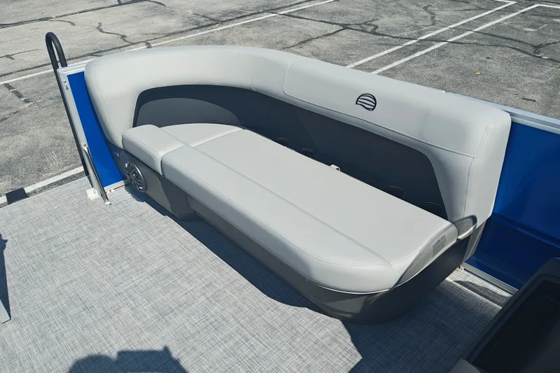Slide: The Image of 2027 Sun Tracker Party Barge 16 DLX pontoon boat with gray seating in a parking lot. - 15
