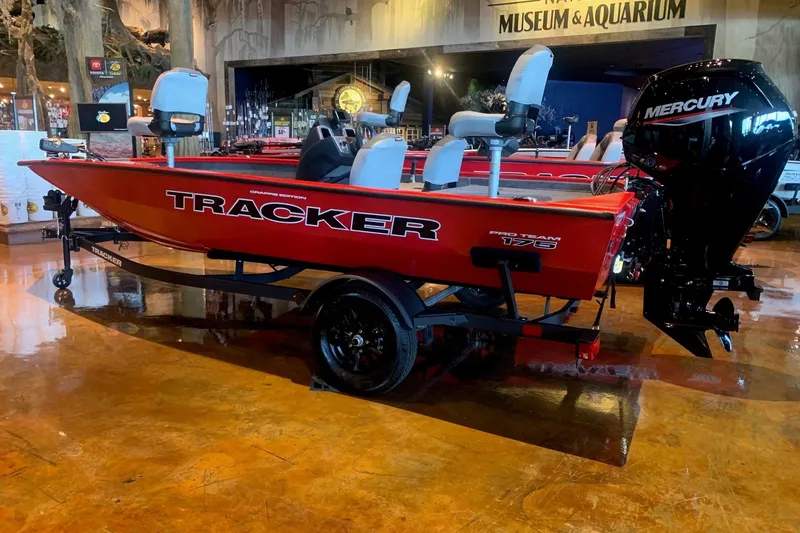 The Image of 2027 Tracker Pro Team 175 Crappie Edition boat displayed indoors with Mercury engine. - 0