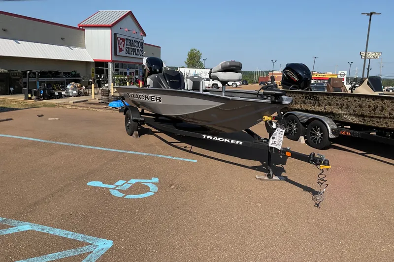 The Image of 2027 Tracker Pro Team 175 Crappie Edition boat on trailer at Tractor Supply Co. parking lot. - 0