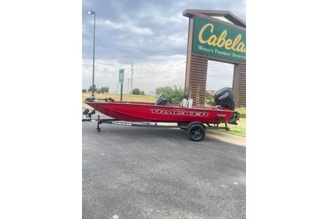 The Image of 2027 Tracker Pro Team 175 Crappie Edition boat parked outside Cabela's store. - 0