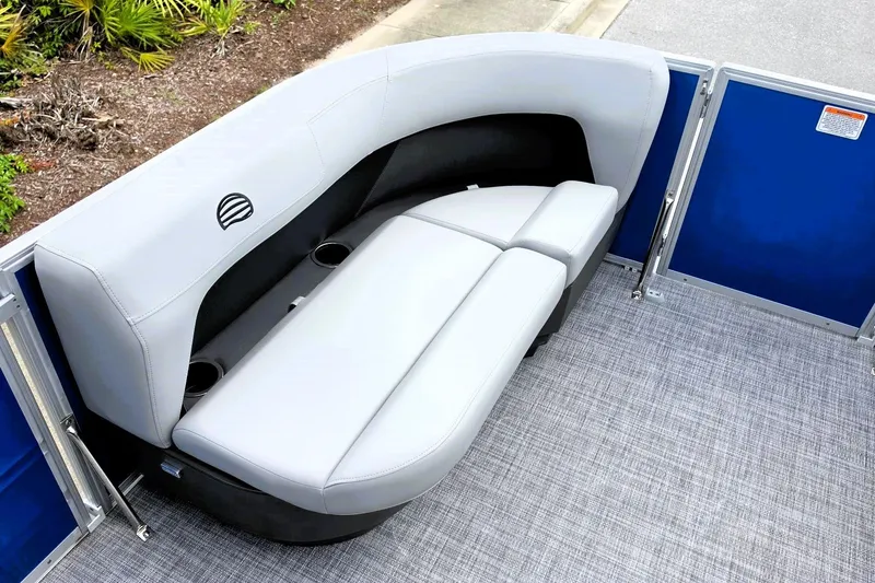 Slide: The Image of 2027 Sun Tracker Party Barge 16 DLX interior seating with gray upholstery and cup holders. - 16