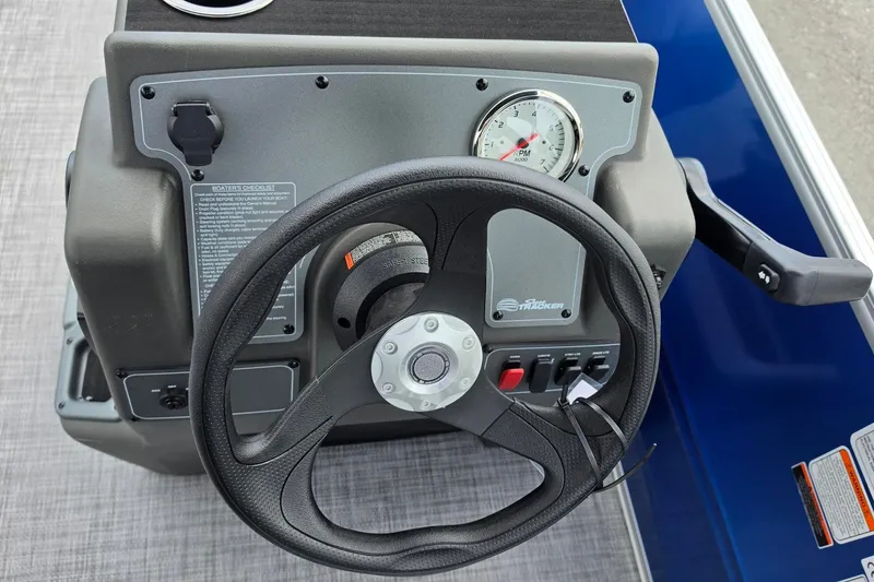 Slide: The Image of Steering console of 2027 Sun Tracker Party Barge 16 DLX with RPM gauge and controls. - 12