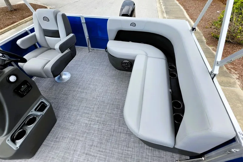 Slide: The Image of 2027 Sun Tracker Party Barge 16 DLX interior with gray seating and modern console. - 14