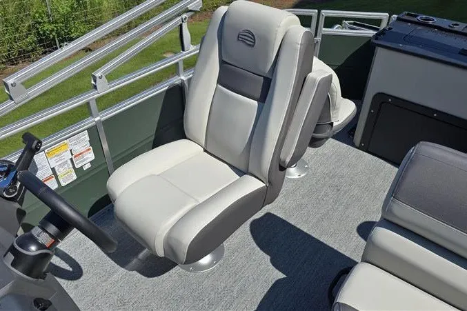 Slide: The Image of 2027 Sun Tracker Fishin' Barge 20 DLX boat interior with comfortable seating and steering wheel. - 12