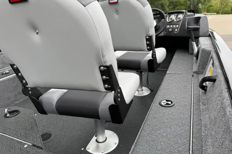 Slide: The Image of 2027 Tracker Pro Guide V-16 SC boat interior with gray seating and dashboard controls. - 23
