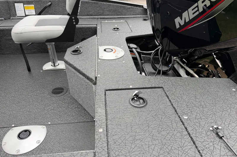 Slide: The Image of 2027 Tracker Pro Guide V-16 SC boat interior with seating and Mercury engine. - 13