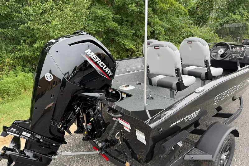 Slide: The Image of 2027 Tracker Pro Guide V-16 SC boat with Mercury engine, parked on a trailer. - 22