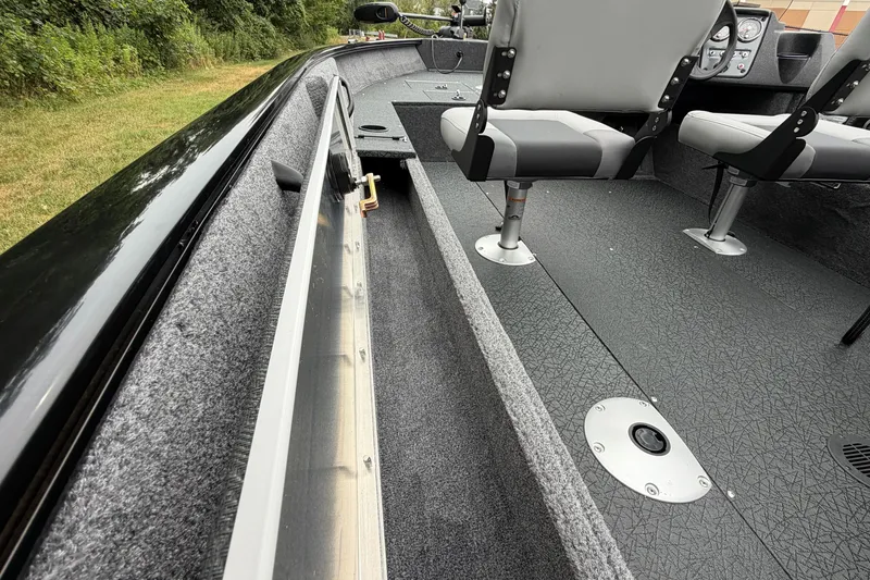 Slide: The Image of 2027 Tracker Pro Guide V-16 SC boat interior with seating and storage compartments. - 16