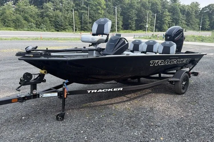 The Image of 2027 Tracker Pro Team 175 Crappie Edition boat on trailer, parked outdoors. - 0