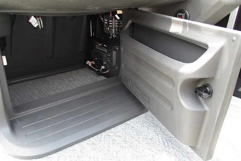Slide: The Image of 2027 Sun Tracker Fishin' Barge 20 DLX storage compartment with electrical components visible. - 34