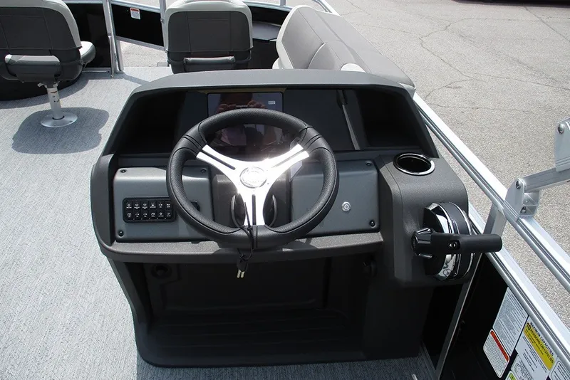 Slide: The Image of 2027 Sun Tracker Fishin' Barge 20 DLX steering console with modern controls and seating. - 36
