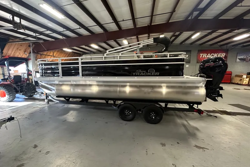 Slide: The Image of 2027 Sun Tracker Fishin' Barge 20 DLX pontoon boat in a warehouse setting. - 64