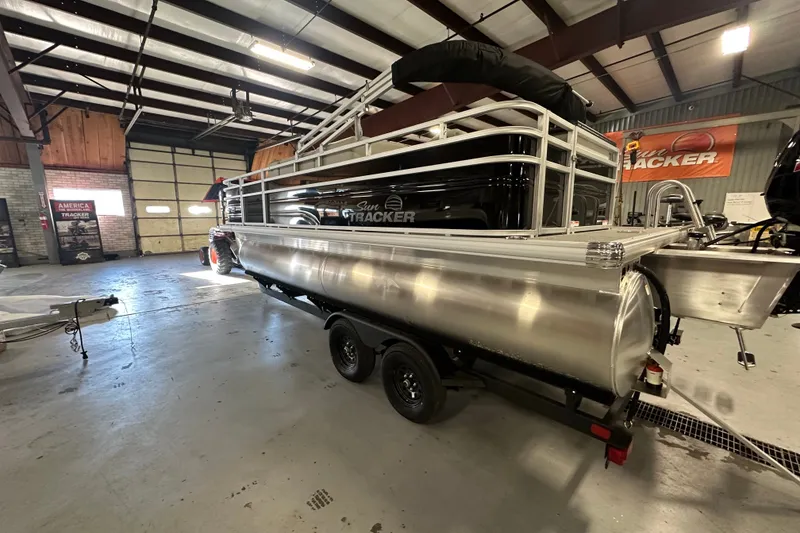 Slide: The Image of 2027 Sun Tracker Fishin' Barge 20 DLX pontoon boat in showroom setting. - 65