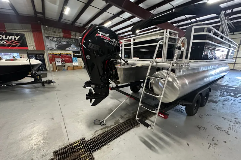 Slide: The Image of 2027 Sun Tracker Fishin' Barge 20 DLX pontoon boat in showroom with Mercury engine. - 67