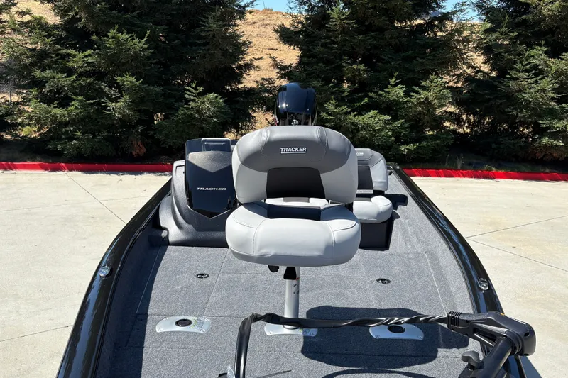 Slide: The Image of 2027 Tracker Pro Team 175 Crappie Edition boat with gray seating, parked outdoors. - 19