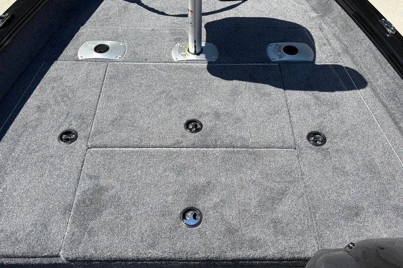 Slide: The Image of 2027 Tracker Pro Team 175 Crappie Edition boat deck with gray carpet and storage compartments. - 32