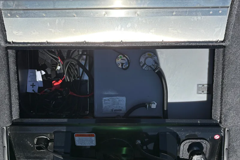 Slide: The Image of Open compartment of 2027 Tracker Pro Team 175 Crappie Edition boat showing wiring and components. - 28