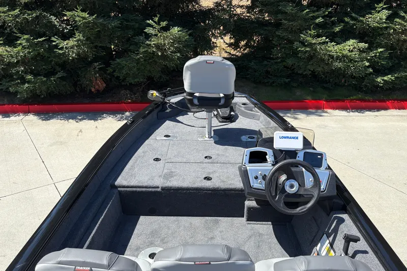 Slide: The Image of 2027 Tracker Pro Team 175 Crappie Edition boat interior with steering wheel and seating. - 17