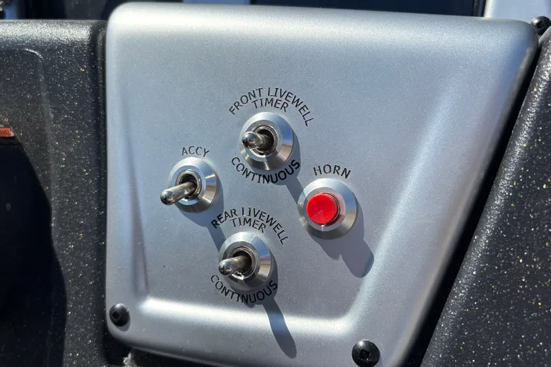Slide: The Image of Control panel of 2027 Tracker Pro Team 175 Crappie Edition boat with switches and horn button. - 24