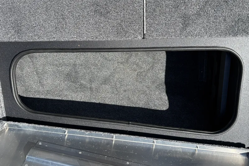 Slide: The Image of 2027 Tracker Pro Team 175 Crappie Edition boat storage compartment, carpeted interior. - 33