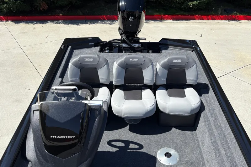 Slide: The Image of 2027 Tracker Pro Team 175 Crappie Edition boat interior with seating and steering console. - 29