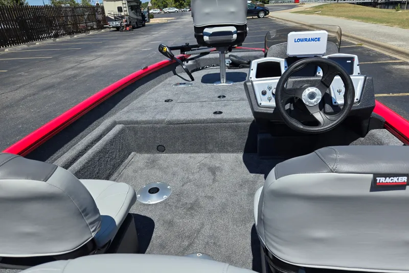 Slide: The Image of 2027 Tracker Pro Team 175 Crappie Edition boat interior with steering wheel and seating. - 13