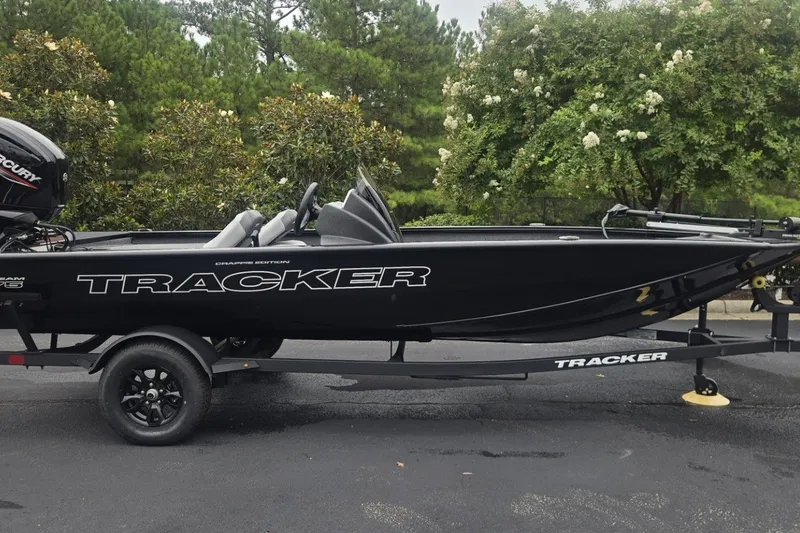The Image of 2027 Tracker Pro Team 175 Crappie Edition boat on trailer, parked outdoors. - 0