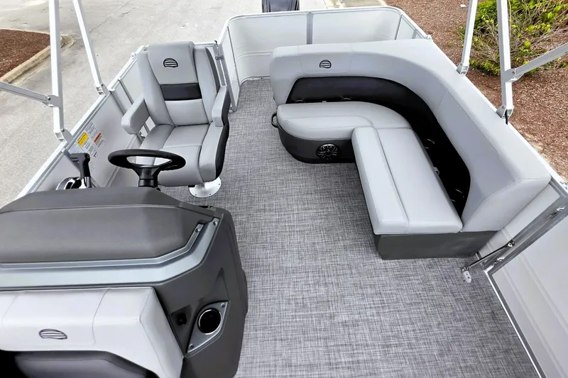 Slide: The Image of 2027 Sun Tracker Party Barge 18 DLX interior with gray seating and steering console. - 15