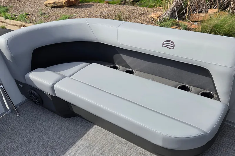 Slide: The Image of 2027 Sun Tracker Party Barge 16 DLX interior seating with cup holders and speaker. - 13