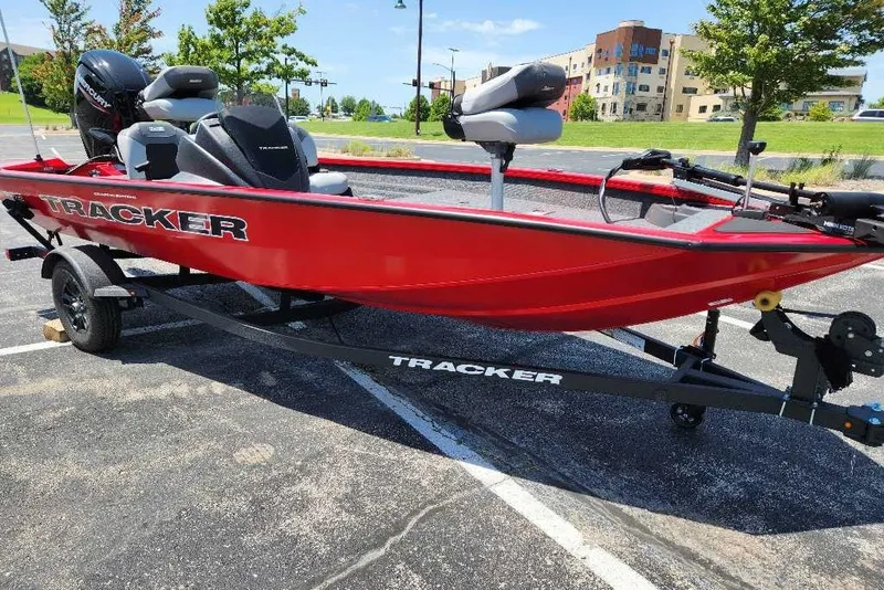 The Image of Red 2027 Tracker Pro Team 175 Crappie Edition boat on trailer in parking lot. - 0