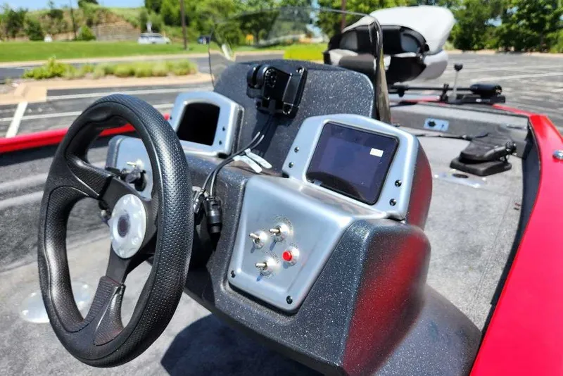 Slide: The Image of 2027 Tracker Pro Team 175 Crappie Edition boat dashboard with steering wheel and controls. - 17